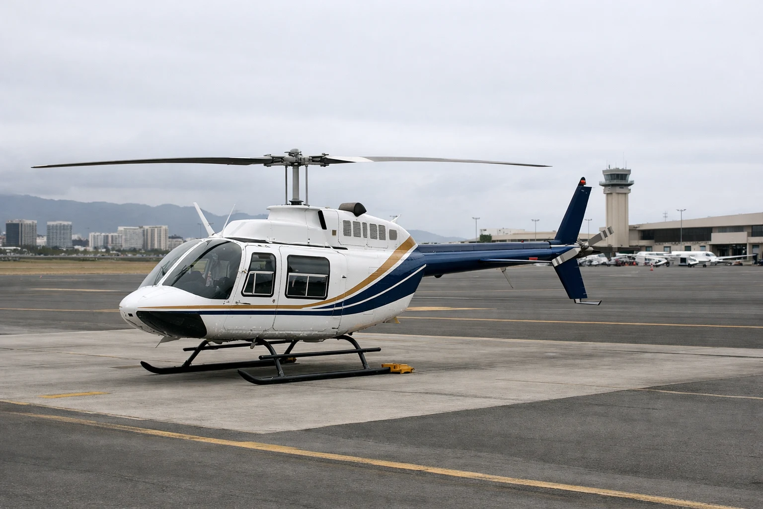 Bell 206B Helicopter on Honolulu Airport Ramp Bell 206B helicopter parked on an airport ramp in Honolulu under overcast daylight