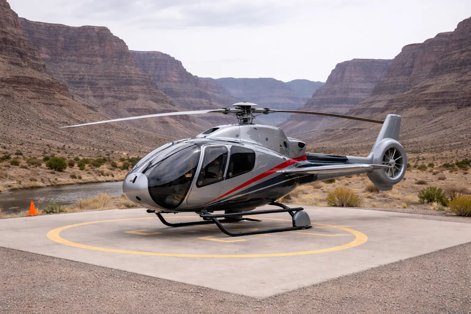 EC130 Tour Helicopter in Canyon Environment Airbus Helicopters EC130 tour helicopter on a helipad in a desert canyon environment
