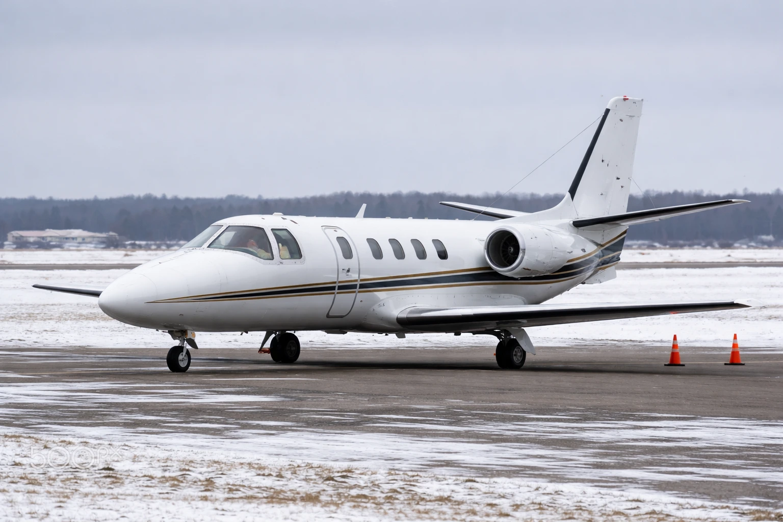 Cessna Citation 550 business jet on a regional airport ramp in overcast daylight