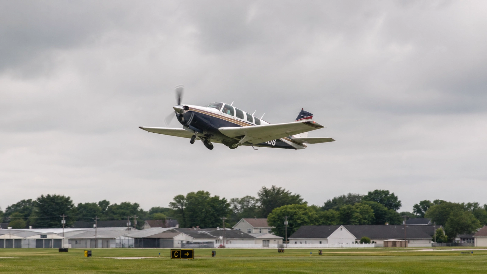 Beechcraft Bonanza Departure from Crystal Airport Beechcraft Bonanza aircraft climbing after takeoff from a suburban airport